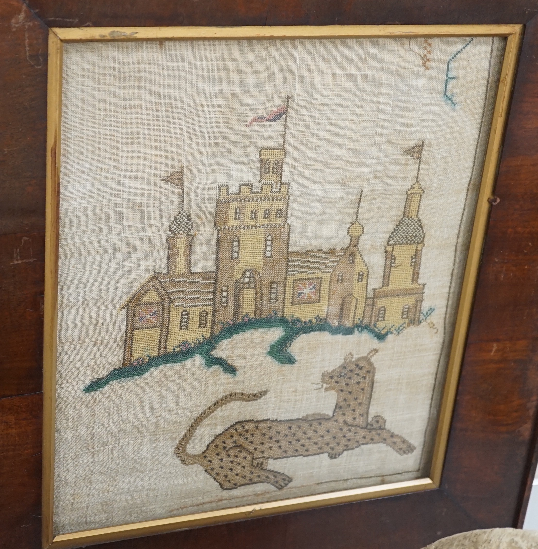 A late Georgian needlework of a leopard and castle , together with a turned wooden framed convex mirror and a similar ebony and gilt framed convex mirror, needlework 31 cms x 36 cms